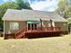 Inviting back deck with railing and stairs, offering outdoor relaxation and access to backyard amenities at 5182 Forest Oaks Dr, Hollywood, SC 29449