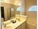 Bright bathroom featuring a double vanity, tub, shower, decorative window, and mirrors at 5182 Forest Oaks Dr, Hollywood, SC 29449