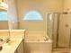 Bright bathroom featuring a tub, shower, decorative window, and vanity at 5182 Forest Oaks Dr, Hollywood, SC 29449