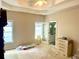 Bright main bedroom with tray ceilings, ceiling fan, access to ensuite bathroom, and natural light at 5182 Forest Oaks Dr, Hollywood, SC 29449