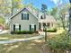Charming home with a welcoming porch, lush landscaping, and beautiful curb appeal in a serene setting at 5182 Forest Oaks Dr, Hollywood, SC 29449