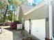 Spacious two-car garage with ample parking, complemented by blooming azaleas and lush greenery at 5182 Forest Oaks Dr, Hollywood, SC 29449