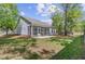 Well-maintained backyard showcasing the home's exterior and a charming screened-in porch at 5560 Alpine Dr, Summerville, SC 29483