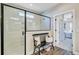 Bathroom with a glass-enclosed shower featuring a black frame, wood flooring, and a decorative bench at 5560 Alpine Dr, Summerville, SC 29483