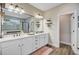 Large bathroom featuring double sinks, quartz countertop, a large mirror, wood flooring, and a walk-in shower at 5560 Alpine Dr, Summerville, SC 29483