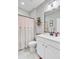 Well-lit bathroom with single vanity, large mirror, and decorative shower curtain at 5560 Alpine Dr, Summerville, SC 29483