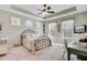 Comfortable bedroom with a tray ceiling, ceiling fan, three windows, and a metal-framed bed at 5560 Alpine Dr, Summerville, SC 29483