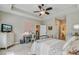 Spacious bedroom with a tray ceiling, fan, tv, three windows, comfortable bed, and ensuite bathroom at 5560 Alpine Dr, Summerville, SC 29483