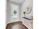 Welcoming foyer features hardwood floors, elegant console table and front door with glass insert at 5560 Alpine Dr, Summerville, SC 29483