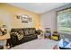 Living room featuring comfortable seating, a Steelers theme, and natural light from the window at 5560 Alpine Dr, Summerville, SC 29483
