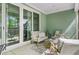 Inviting outdoor patio featuring comfortable seating, a ceiling fan, and sliding glass doors at 5560 Alpine Dr, Summerville, SC 29483