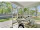 Inviting screened porch with comfortable seating and wooded views, perfect for enjoying the outdoors at 5560 Alpine Dr, Summerville, SC 29483