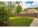 Spacious backyard featuring a well-maintained lawn and tall wooden fence, perfect for outdoor activities and privacy at 5573 Betty Ct, North Charleston, SC 29418