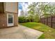 A green backyard features a trimmed lawn, a concrete patio, and a wood fence at 5573 Betty Ct, North Charleston, SC 29418