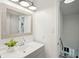 Bright bathroom features a gray vanity, framed mirror, decorative lighting, and direct access to the upstairs at 5573 Betty Ct, North Charleston, SC 29418