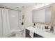 Bathroom with combined shower-tub, marble tile, framed mirror, vanity, and butterfly art at 5573 Betty Ct, North Charleston, SC 29418