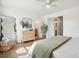 Bright and airy bedroom with wood floors, modern decor, and ensuite bathroom access at 5573 Betty Ct, North Charleston, SC 29418