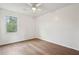 The bedroom features hardwood floors, a ceiling fan, and a bright window with views of the yard at 5573 Betty Ct, North Charleston, SC 29418