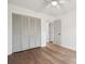 This bedroom features a ceiling fan, hardwood floors, and a gray closet with access to other rooms at 5573 Betty Ct, North Charleston, SC 29418