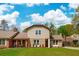 Charming two-story home featuring a well-manicured lawn and welcoming front porch with brick accents at 5573 Betty Ct, North Charleston, SC 29418