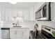 Modern kitchen with stainless steel appliances, white cabinets, quartz counters, and subway tile backsplash at 5573 Betty Ct, North Charleston, SC 29418