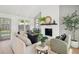 Bright living room with whitewashed brick fireplace, beamed ceiling, and stylish decor at 5573 Betty Ct, North Charleston, SC 29418