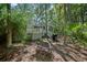 Backyard showing a bench, grill and a wooded landscape around the home at 597 Oyster Rake Dr, Kiawah Island, SC 29455