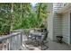 Spacious deck with an outdoor dining set and scenic views of the surrounding trees at 597 Oyster Rake Dr, Kiawah Island, SC 29455