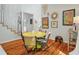 Bright dining room featuring a striking yellow table and wood floors at 597 Oyster Rake Dr, Kiawah Island, SC 29455