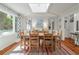 Open dining room with wood table, skylight, and colorful area rug at 597 Oyster Rake Dr, Kiawah Island, SC 29455