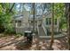 Exterior of home featuring a grill, deck, and wooded surroundings at 597 Oyster Rake Dr, Kiawah Island, SC 29455