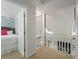 Upstairs hallway featuring a bedroom view and skylight at 597 Oyster Rake Dr, Kiawah Island, SC 29455