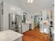 Bright, white kitchen with stainless appliances and hardwood floors at 597 Oyster Rake Dr, Kiawah Island, SC 29455