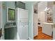 Functional laundry area with stacked washer and dryer with view to kitchen at 597 Oyster Rake Dr, Kiawah Island, SC 29455