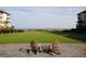 Expansive lawn with ocean views and Adirondack chairs create a relaxing outdoor space at 597 Oyster Rake Dr, Kiawah Island, SC 29455