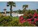 Relaxing resort pool surrounded by lush landscaping and a tropical vibe for luxurious outdoor living at 597 Oyster Rake Dr, Kiawah Island, SC 29455