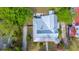 Aerial view of a charming home with a metal roof, surrounded by lush greenery and a patio area at 617 Hampton St, Walterboro, SC 29488