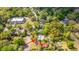 Aerial shot pointing to a home in a neighborhood with tree-lined streets, houses, and commercial buildings at 617 Hampton St, Walterboro, SC 29488