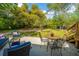 Outdoor patio area with stylish wicker seating and a metal dining table, perfect for enjoying the serene backyard ambiance at 617 Hampton St, Walterboro, SC 29488
