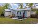 The back of this house has a patio with seating, stairs, and a grassy backyard at 617 Hampton St, Walterboro, SC 29488