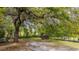 Backyard featuring a small outbuilding, large trees and sandy ground at 617 Hampton St, Walterboro, SC 29488