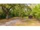 Backyard featuring a small outbuilding, large trees and sandy ground at 617 Hampton St, Walterboro, SC 29488