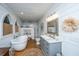 Bright bathroom featuring shiplap walls, soaker tub, walk-in shower, and vanity with marble countertop at 617 Hampton St, Walterboro, SC 29488