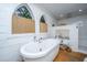 Bright bathroom with a soaking tub next to cathedral windows and a tiled walk-in shower at 617 Hampton St, Walterboro, SC 29488