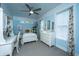 Comfortable bedroom with light-blue walls, white furniture, ceiling fan, and carpeted floors at 617 Hampton St, Walterboro, SC 29488