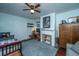 Bright bedroom with wood floors, a decorative fireplace, and light blue walls, creating a serene and inviting space at 617 Hampton St, Walterboro, SC 29488