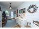 Cozy entryway with hardwood floors, white dresser, and a decorative feather wreath at 617 Hampton St, Walterboro, SC 29488