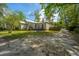 Quaint home with a sprawling yard, inviting porch, and unique architectural details, exuding a welcoming and timeless charm at 617 Hampton St, Walterboro, SC 29488