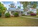 Charming home with a metal roof, front porch with rocking chairs, and landscaping at 617 Hampton St, Walterboro, SC 29488