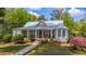 Charming single-story home featuring a welcoming front porch with rocking chairs and lush landscaping at 617 Hampton St, Walterboro, SC 29488